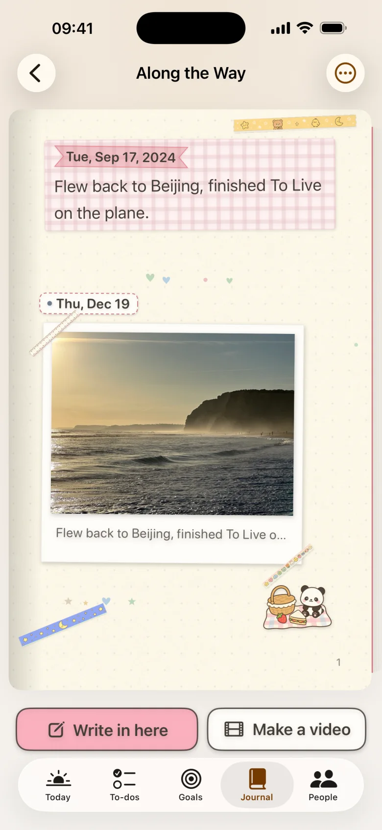 An open notebook page with handwritten date labels, tape, stickers and entries
